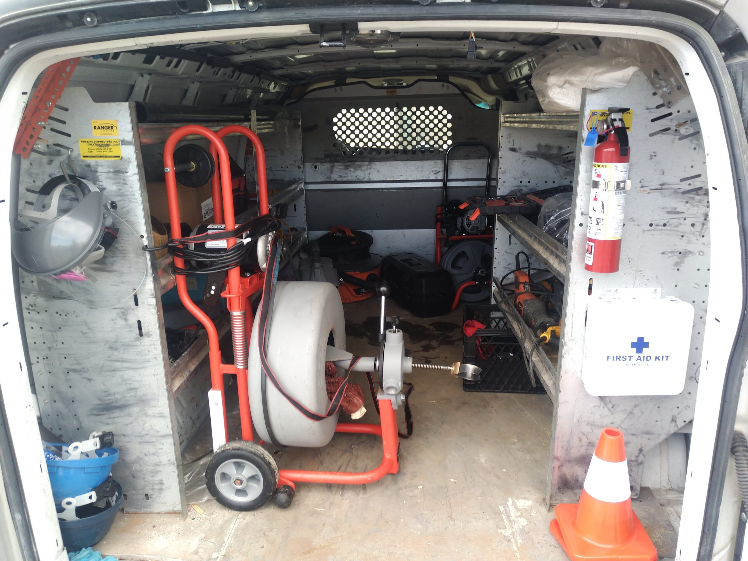 Drain-cleaning and augering equipment loaded in a Done Deal service van